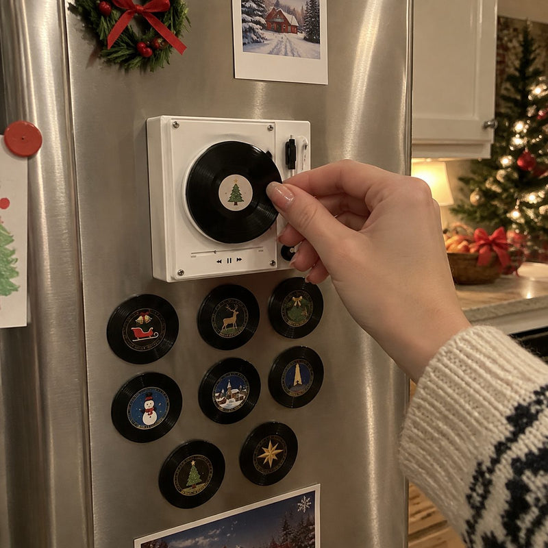 Hand placing a mini record on the magnetic fridge player