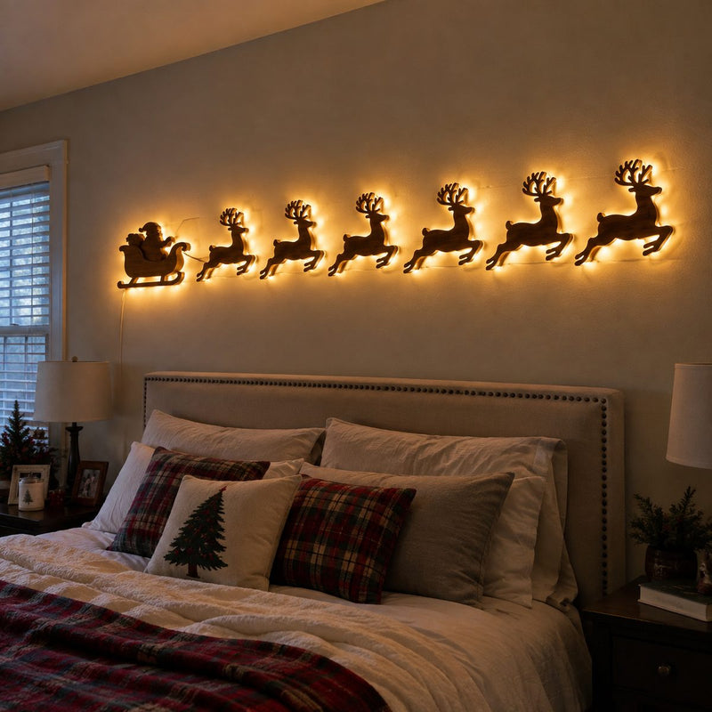 Backlit reindeer row wall lights above a bed
