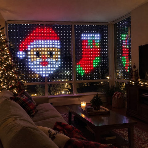 LED curtain lights showing a pixel Santa in a living room window