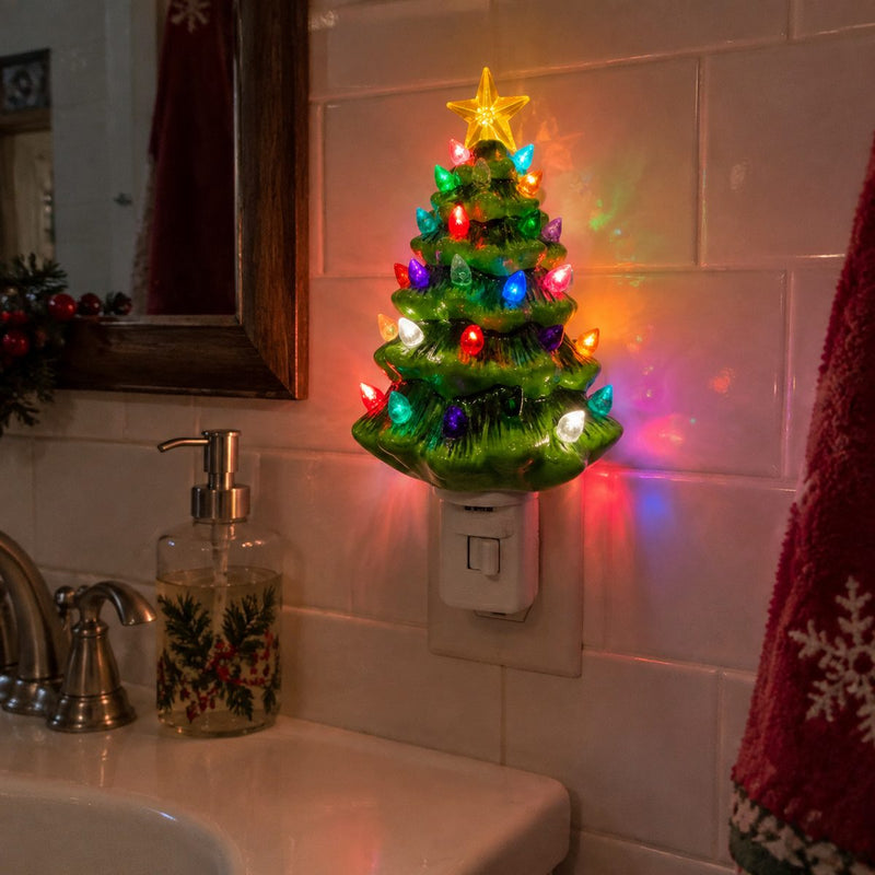 Ceramic Christmas tree night light glowing in a bathroom